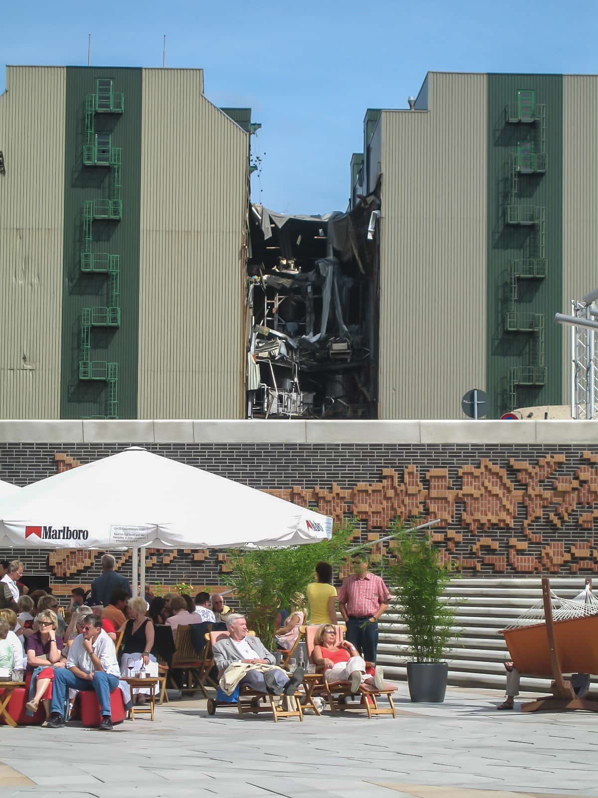 Abriss einer Fabrik vor einer Kaffeeterrasse